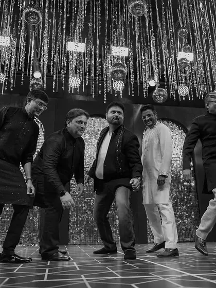 This black and white shot captures the fun and camaraderie of the 'Ganpats'. A group of friends and family bringing their A-game and energy to the Sangeet stage.