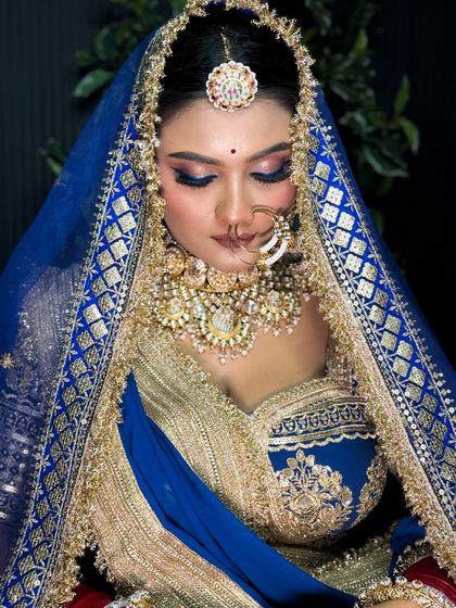 A close-up of the Rajputi bride with her eyes closed, showcasing the beautiful blend of blue and pink eyeshadow.