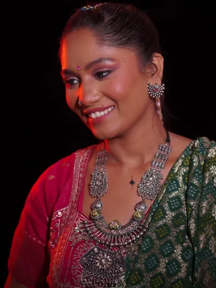 A happy, smiling portrait of the model. The makeup enhances her beautiful features without overpowering them.