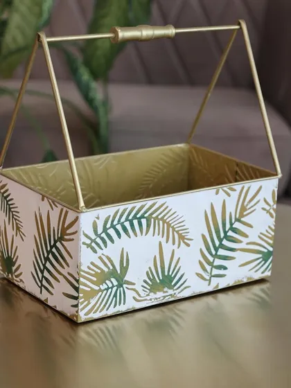 A single metal basket with our signature green leaf print. Its compact size and elegant handle make it a versatile piece for any room in the house.