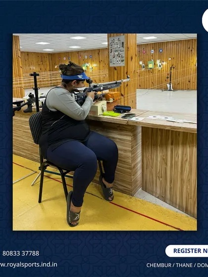 A female shooter takes aim from a seated position at our range. We provide a supportive environment for everyone to pursue their goals, whether for recreation or competitive sport.