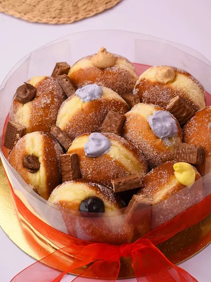 For the person who just can't have enough donuts, we present The Donut Cake. This is a collection of our delicious, filled Berliner donuts arranged like a cake, perfect for a fun and unique birthday treat.