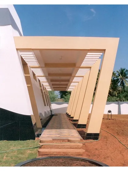 The pergola-d walkway at the CC Office in Tuticorin (2002). The repeating, tapered columns create a strong visual rhythm and a sheltered path, a design element that has been a recurring theme in our work over the years.