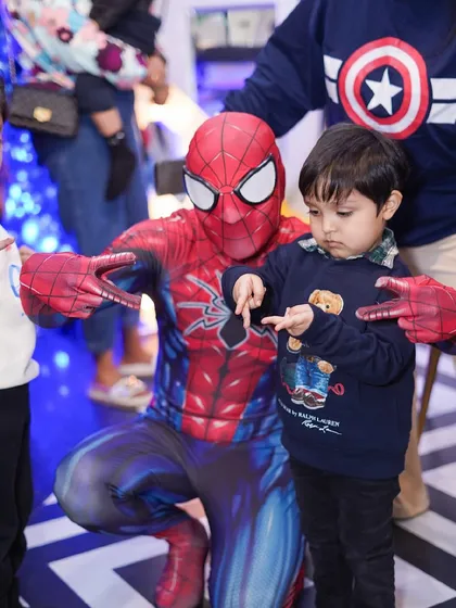 Imagine your child's excitement meeting their favorite hero. Our exclusive party packages can include a mascot visit, like this awesome interaction with Spider-Man, creating a core memory for your little one.