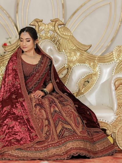 This bride's reception look was grand and regal. Her deep red velvet lehenga was the centerpiece, and I created a classic, timeless makeup look to match.