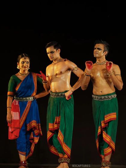 A character interaction from 'Nagamandala'. The expressions and postures here tell a story of persuasion and skepticism, a key element of narrative dance.