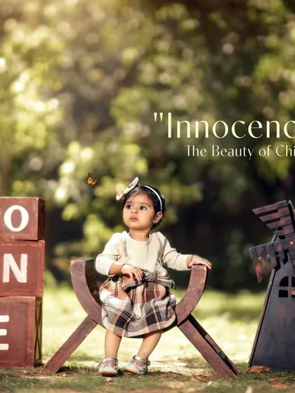 Capturing a moment of quiet wonder during an outdoor first birthday session. The natural setting and rustic props create a timeless, vintage feel.