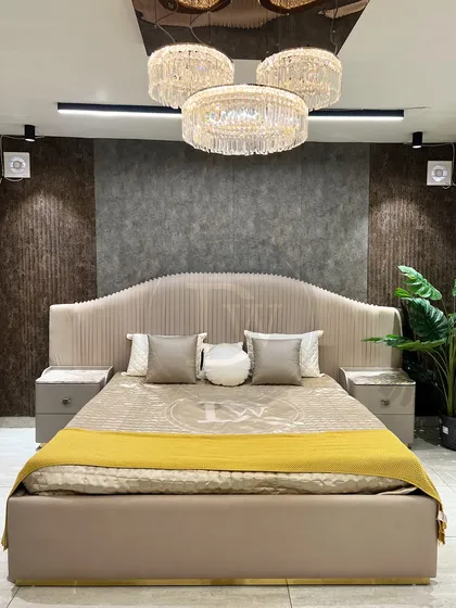 Your bedroom should be a retreat. We designed this grand, fully upholstered bed to be the centerpiece of your sanctuary. Notice the channel-tufted headboard and the elegant proportions, all crafted in our workshop to create a feeling of pure luxury.