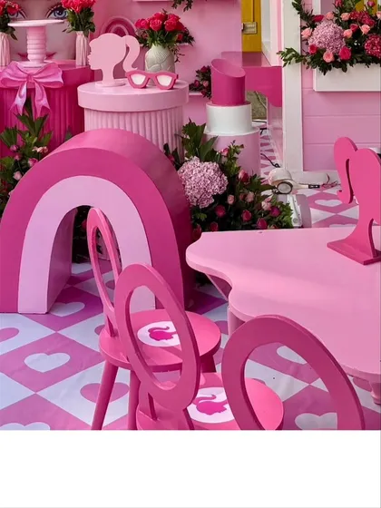 Details of the Barbie decor, including a pink rainbow prop and custom-designed chairs.