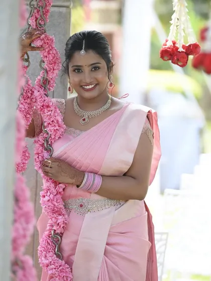 Capturing that moment of pure joy is what I live for. Dr. Namratha looks absolutely radiant during her outdoor ring ceremony. For this daytime event, I used a fresh and natural makeup palette to enhance her features, ensuring she looked and felt like the best version of herself in her beautiful pink silk saree.