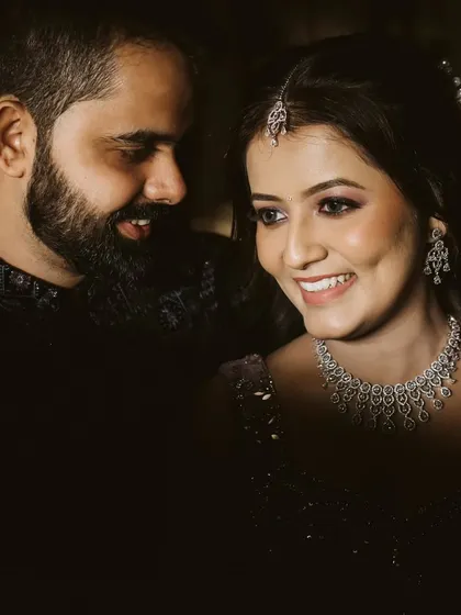 A sweet, candid moment where the groom looks lovingly at his bride. Her bright, happy smile is the centerpiece of this intimate and joyful portrait.