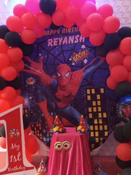 A close-up of our action-packed Spiderman theme decoration. The setup includes a custom backdrop, a red and black balloon arch, and a themed cake table, perfect for a superhero's first birthday.