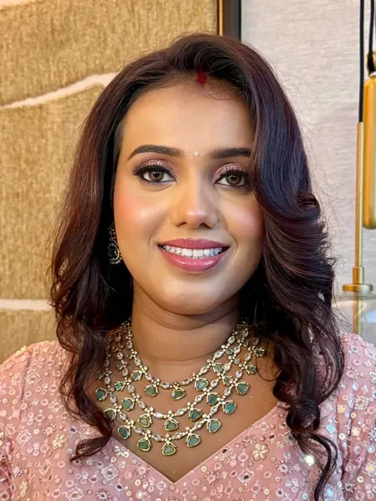 A happy, confident client. The makeup is subtle yet impactful, enhancing her natural beauty.