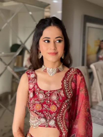 The bride-to-be looks radiant with her romantic hairstyle, perfect for her engagement ceremony.