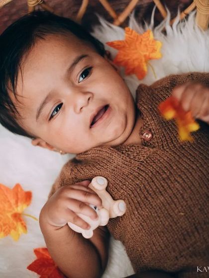A beautiful close-up of a baby playing in a basket. This candid shot captures a quiet, happy moment during one of our baby photoshoots.