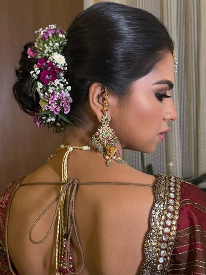 Another angle of the purple and white floral bun, highlighting the intricate twists and the placement of each flower.