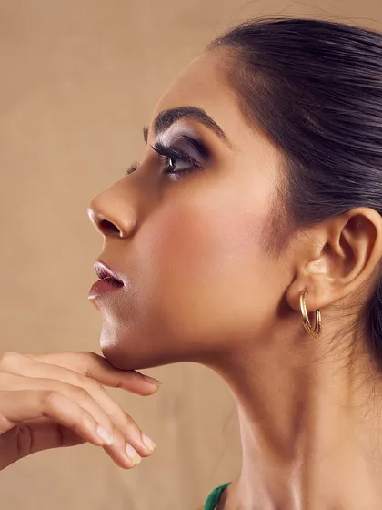 The smokey eye is an art form. This profile shot captures the depth and dimension of a blended smokey look, designed to make the eyes the undeniable focal point. It is paired with a glossy neutral lip to maintain balance.