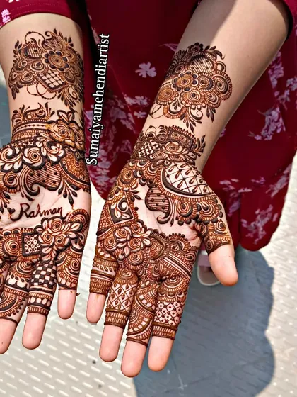 This Indo-Arabic henna design was inspired by another artist and features a personalized name, 'Rahman'.
