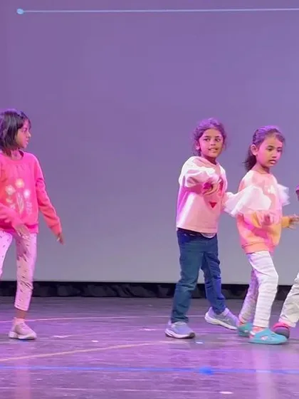 A group of children practicing their dance moves on stage. Rehearsals are a time for learning, collaboration, and fun.