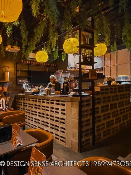 Another angle of our industrial-chic cafe design. The warm glow from the paper lanterns contrasts beautifully with the raw texture of the concrete block counter, creating a space that is both cozy and cool.