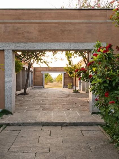 A stone gateway frames a view through the courtyards of the H.N. Science Center, creating a layered experience of moving through the space.
