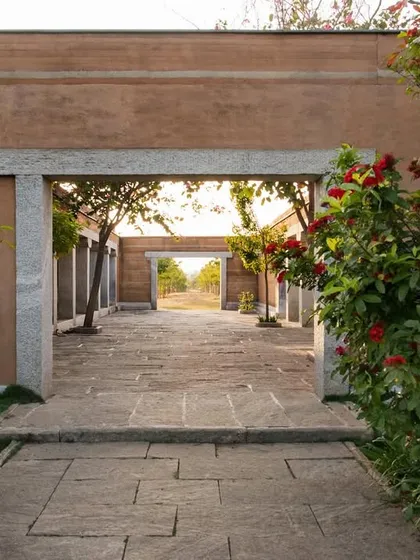 A stone gateway frames a view through the courtyards of the H.N. Science Center, creating a layered experience of moving through the space.