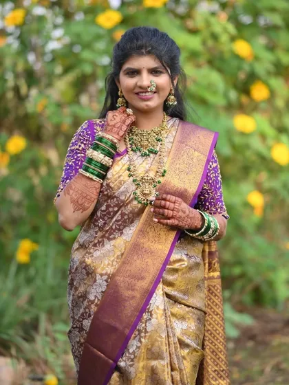A full-length shot of the same bride, capturing her complete look against a beautiful floral background.