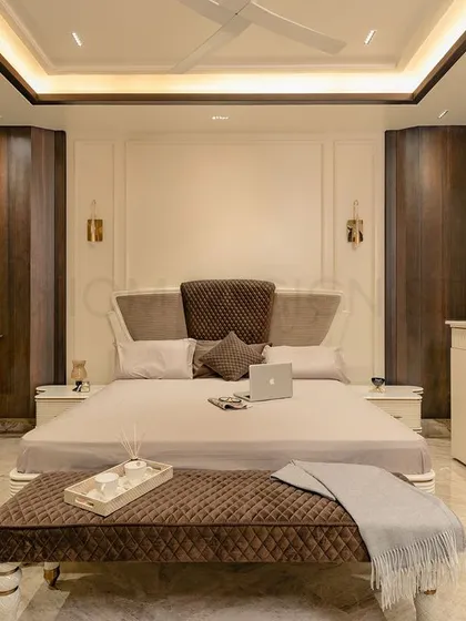 This parent's bedroom was designed around the client's specific vision. The walls are kept simple, allowing the intricately designed custom furniture and rich textures to stand out.
