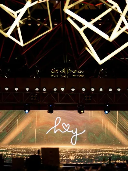 The stage backdrop featured a massive LED screen with custom graphics, perfectly integrated with the overhead lighting design.