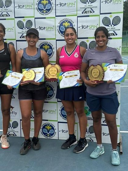 The winners and runners-up from the AITA 1 lakh Women's tournament, with our player and her partner holding their champions' plaques.
