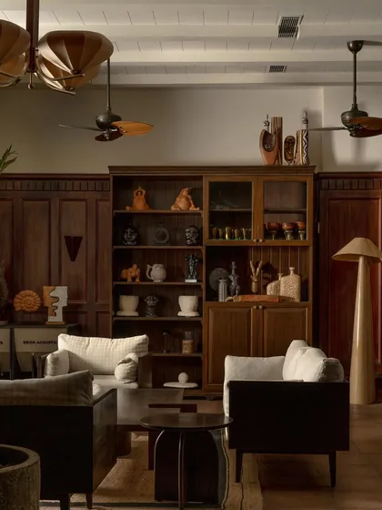 A curated display cabinet filled with pottery and artifacts, adding a layer of personality and storytelling to the space.