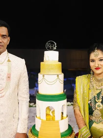 The couple stands proudly next to their grand engagement cake, a symbol of their new beginning.