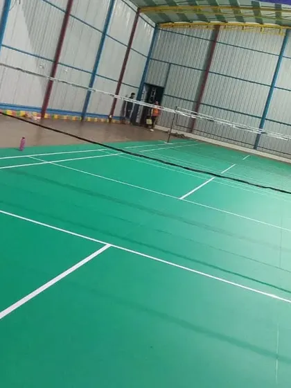 A clear view of one of our professional-grade indoor badminton courts. The space is well-lit with high ceilings and proper flooring, ready for training and matches.