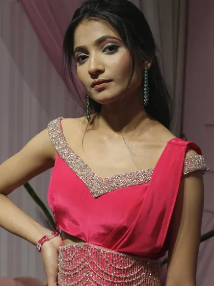 A close-up of the embellished off-shoulder neckline on our pink draped saree.