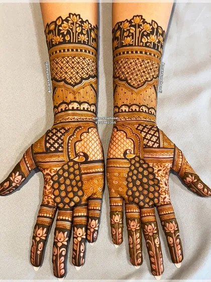 A symmetrical bridal design featuring majestic peacocks on the palms. The arms are decorated with bands of floral and geometric patterns, creating a full and balanced look.