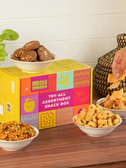 An assortment snack box with various snacks displayed in bowls, giving customers a clear idea of the variety inside.