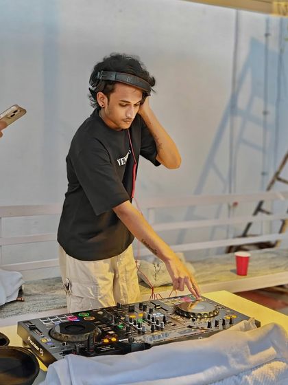 Tuning into the frequency of an afternoon party. Headphones on, world off, ready to mix the perfect set for a relaxed yet energetic open-air event.