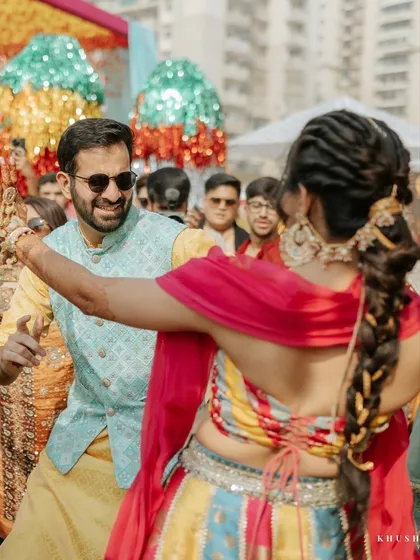 A beautiful candid of the couple dancing, with the colorful decor and performers in the background.