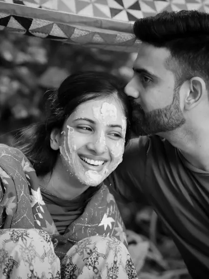 A tender moment amidst the fun of the Haldi. A gentle kiss on the forehead is a quiet expression of love and support, beautifully captured in black and white.