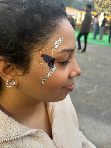 Here’s a different take on the butterfly theme, using glitter to create the shape of the wings. This technique is super popular at festivals and concerts for a quick and glamorous look.