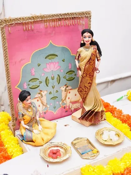 This scene from a baby shower *rukhwat* shows a mother and child with a backdrop inspired by Pichwai art. We love blending traditional art forms into our doll setups to create something truly unique.