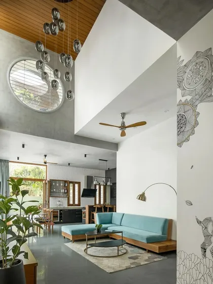 This double-height lounge is the heart of the home, designed to connect spaces, people, and nature. I used a mix of honest materials like a random rubble stone wall and a warm wooden ceiling to create a space that feels both grand and grounded.