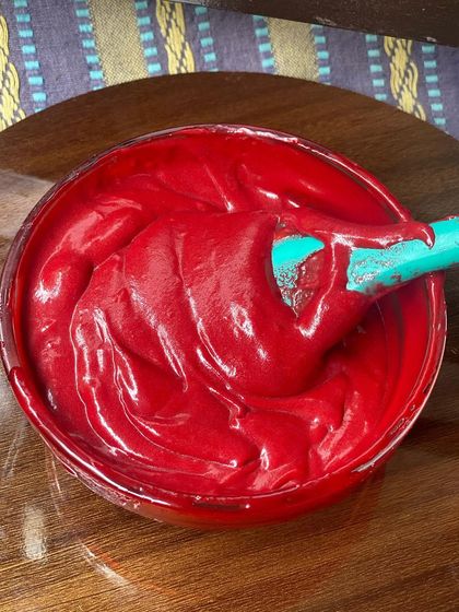 This is the rich, vibrant red velvet brownie batter before it goes into the oven. The thick consistency promises a perfectly dense and moist final product.