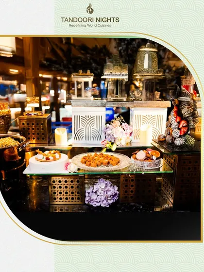 Where love and flavor blend seamlessly. This shot captures a section of one of our wedding buffet setups, featuring elegant serving dishes and beautiful floral arrangements.