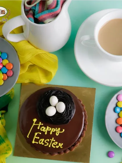 A mini chocolate truffle cake for Easter, decorated with a chocolate nest and sugar eggs. A rich and festive treat.
