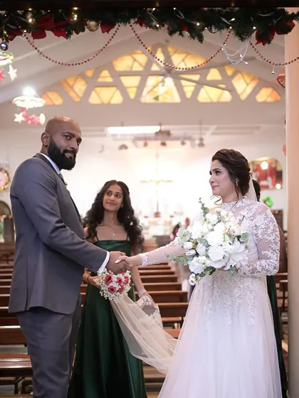 "I do." A beautiful shot of the couple during their wedding ceremony, with the bridesmaid looking on.