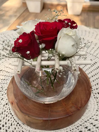 A detailed look at one of the Christmas floral bowls. The combination of classic holiday colors with natural wood and bamboo elements creates a cozy and festive feel.