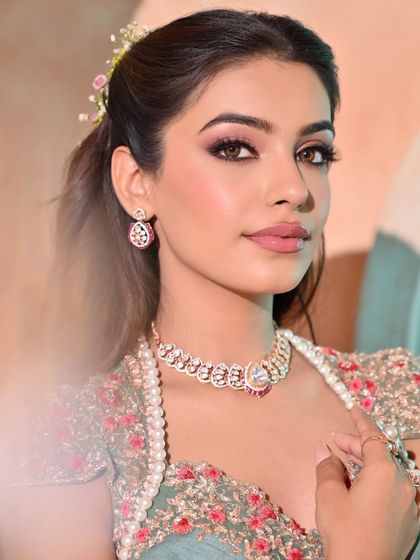 A close-up portrait that shows how the soft, wavy hairstyle frames the face beautifully, enhancing the bride's soft glam makeup.