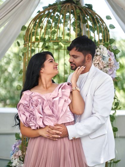 A sweet and romantic pose from a pre-wedding maternity shoot. The 'Bloom' gown's intricate floral bodice is the centerpiece of this lovely image.
