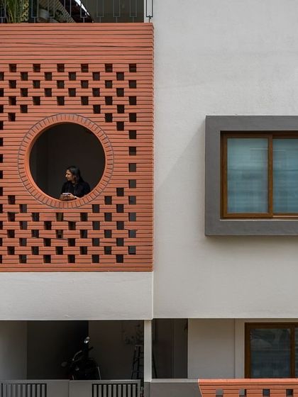 Another angle of the Mathrukrupa facade, showcasing its balanced composition of solid and perforated surfaces.